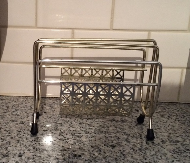 A vintage napkin holder that looks like a mini magazine rack. Photo by Holly Tierney-Bedord. All rights reserved.